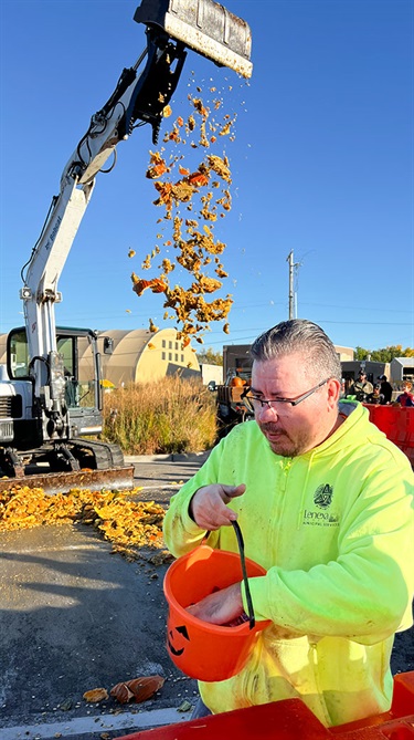 Excavator drops pumpkin parts from a great height