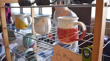 Ceramic mugs on rack