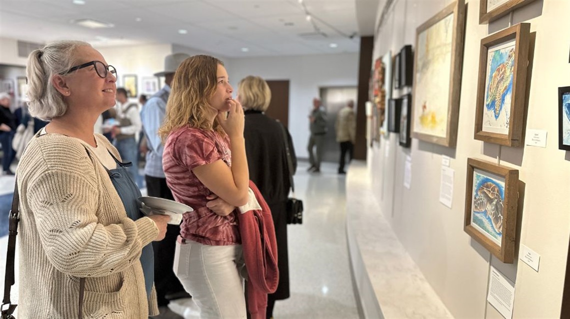 Two women contemplating art at the City Hall Art Gallery