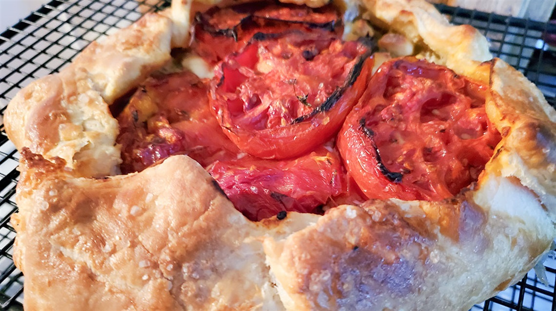 closeup of tomato galette on cooling rack