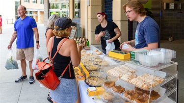 Yellow Brick Bakery vendor booth with customers