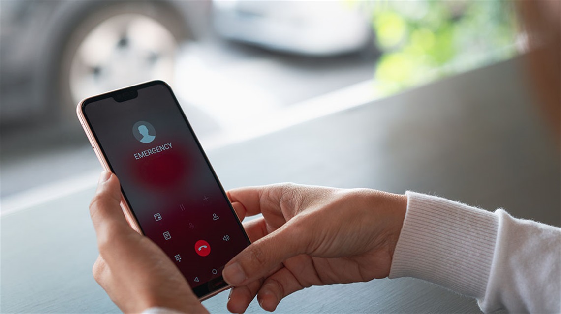 hands holding cell phone with emergency screen visible