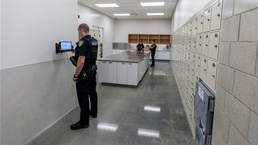 Officer in evidence property storage area at Lenexa Justice Center