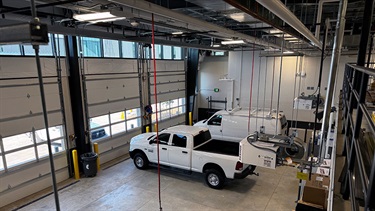 Interior of maintenance building at Lenexa Justice Center with several fleet vehicles