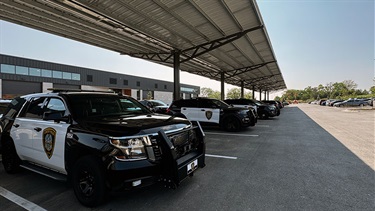 Secure, covered outdoor parking for patrol cars at Lenexa Justice Center