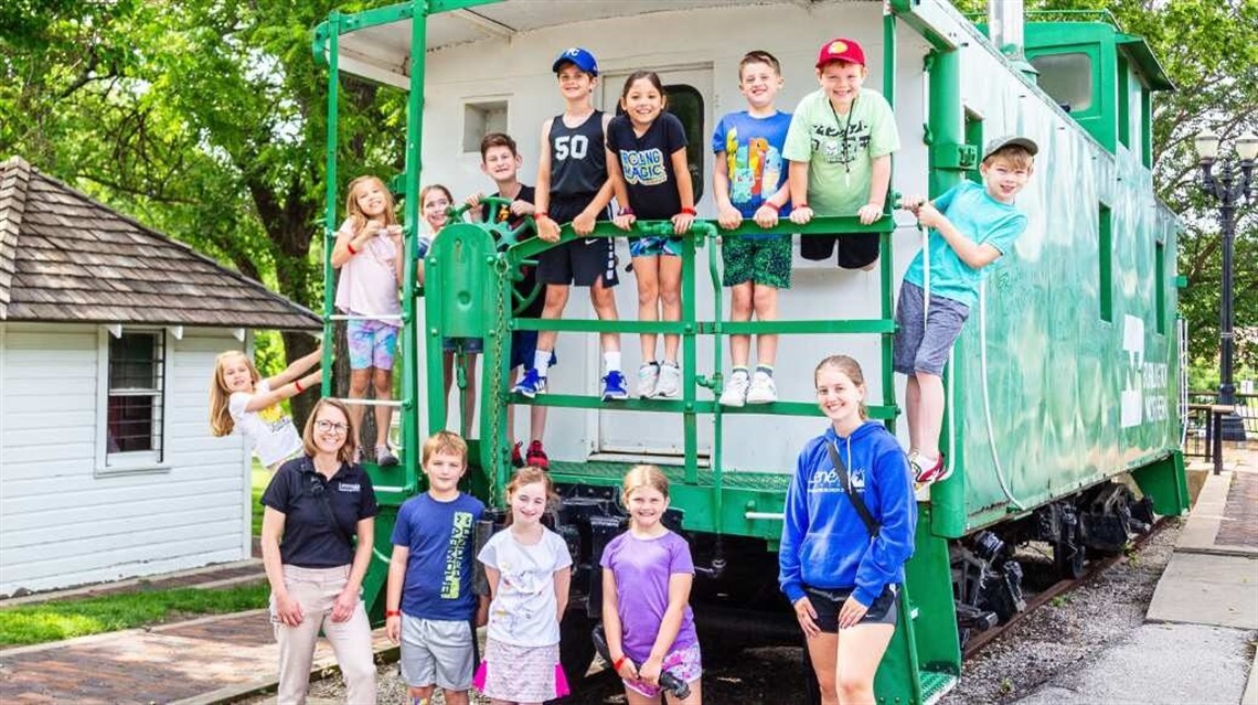 Summer camp counselors and group of kids in Lenexa.