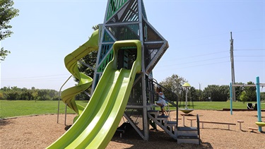 Girl climbing stairs on playground equipement