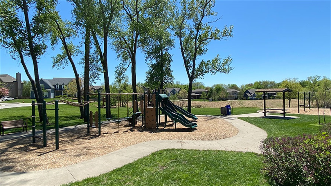 Overview of park with play equipment and trees